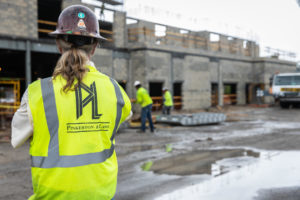 construction worker supervising construction of a concrete building